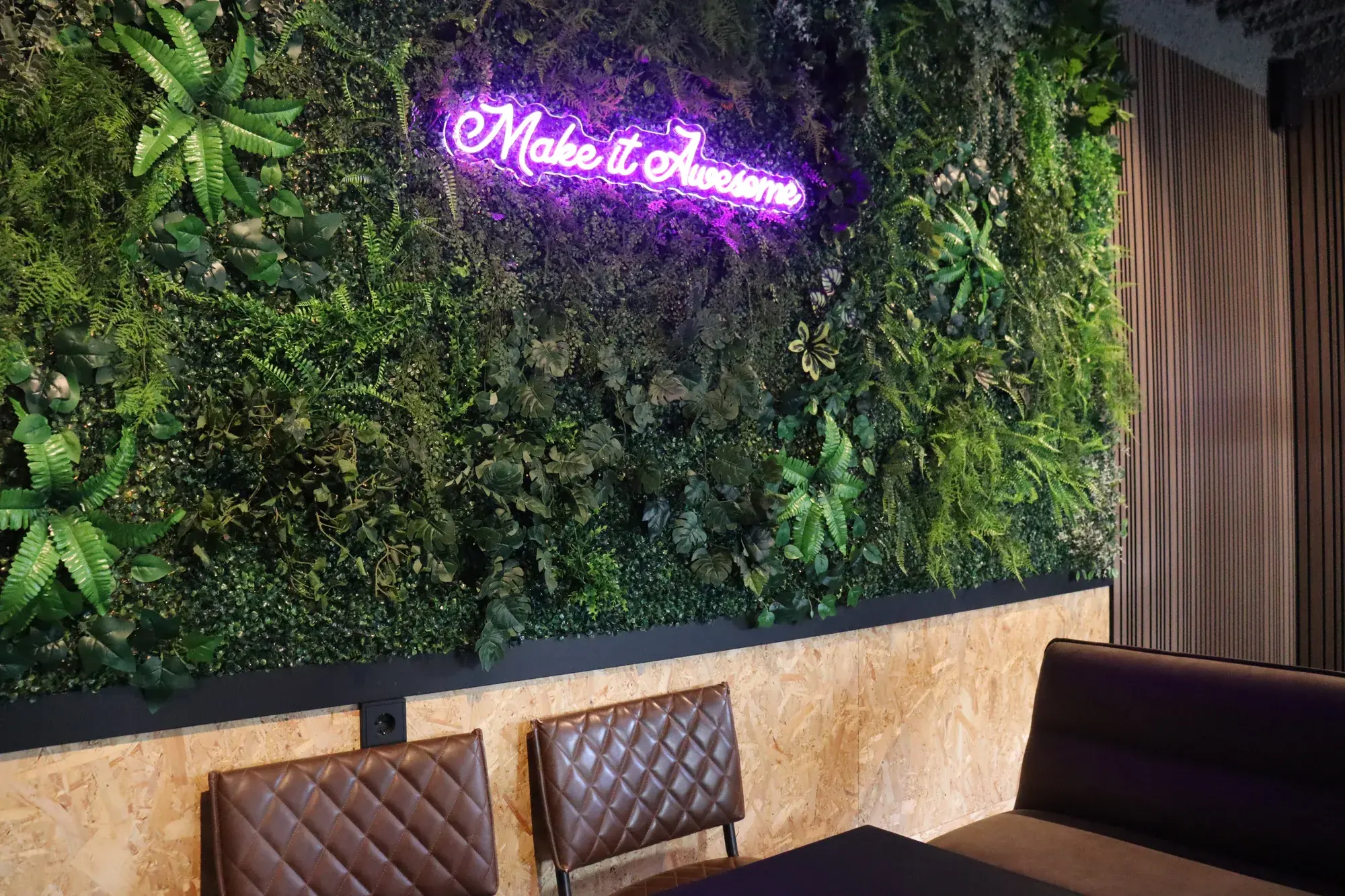 De plantenwand van De HUP met neonbord